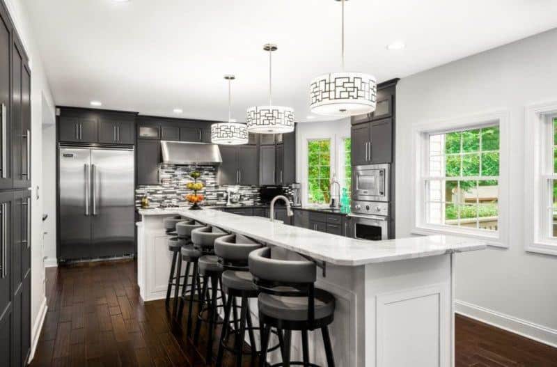 grey kitchen with white island with bar seating 