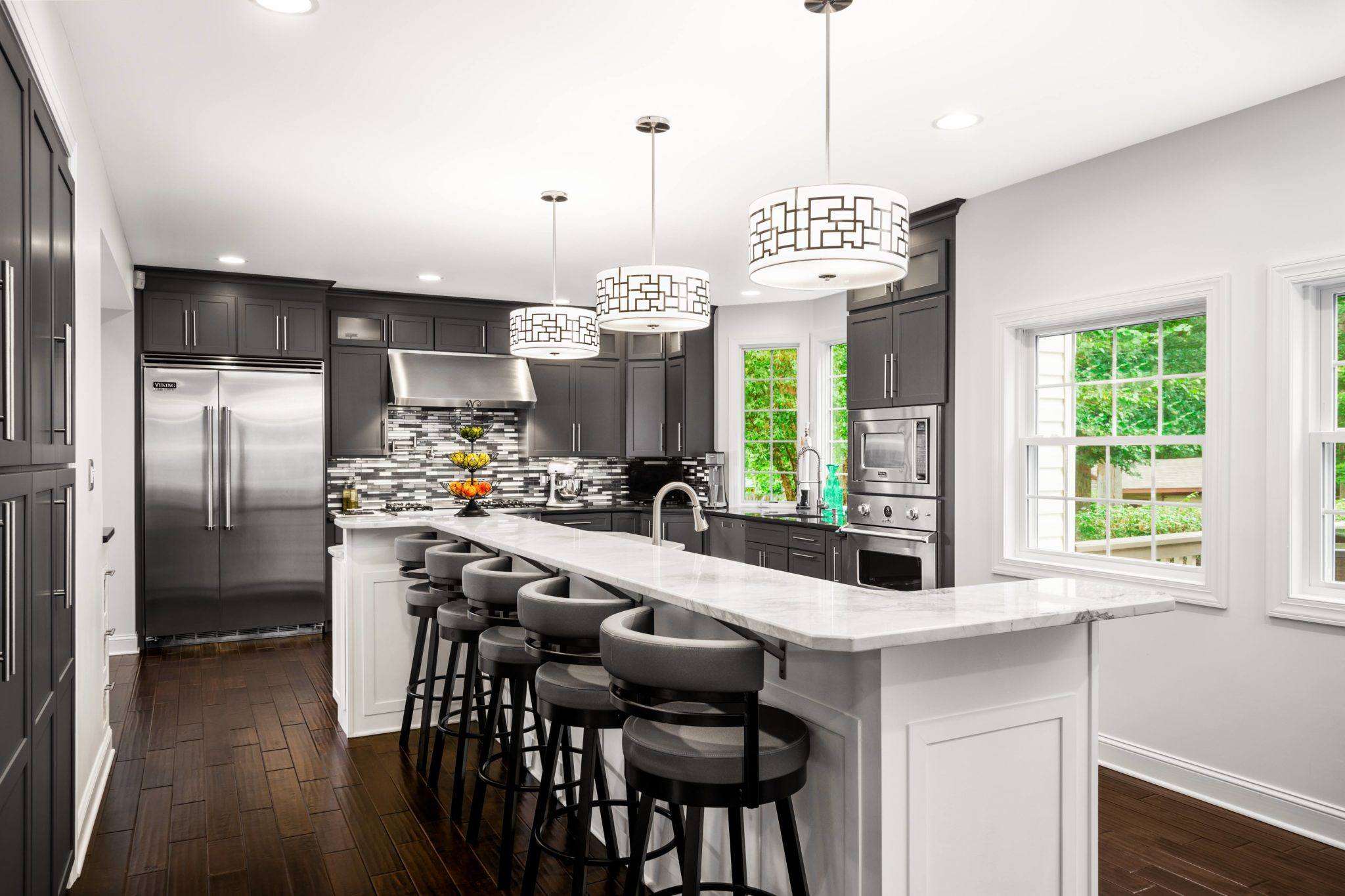 Kitchen designed with Bishop cabinets in a custom, color-matched grey and brilliant white with stainless steel Viking appliances.