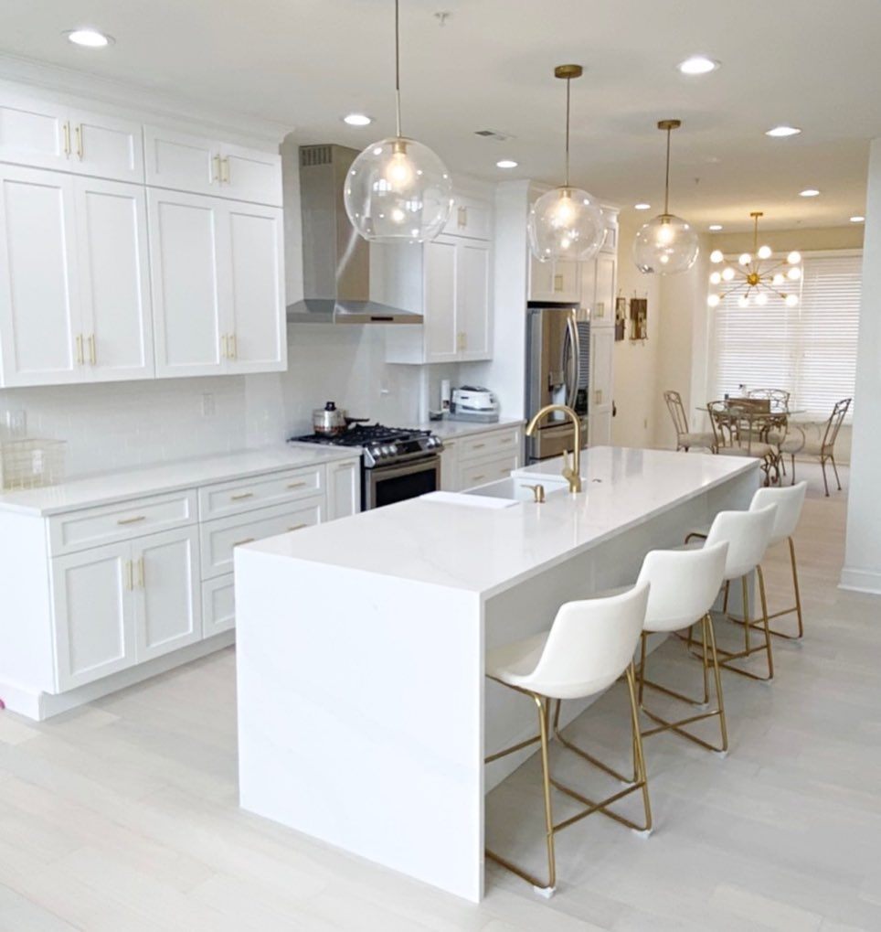 white kitchen with seating at the island
