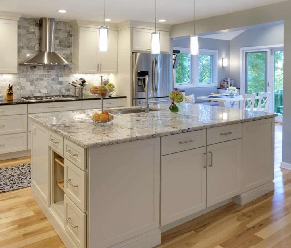 White shaker kitchen with island and quartzite top.