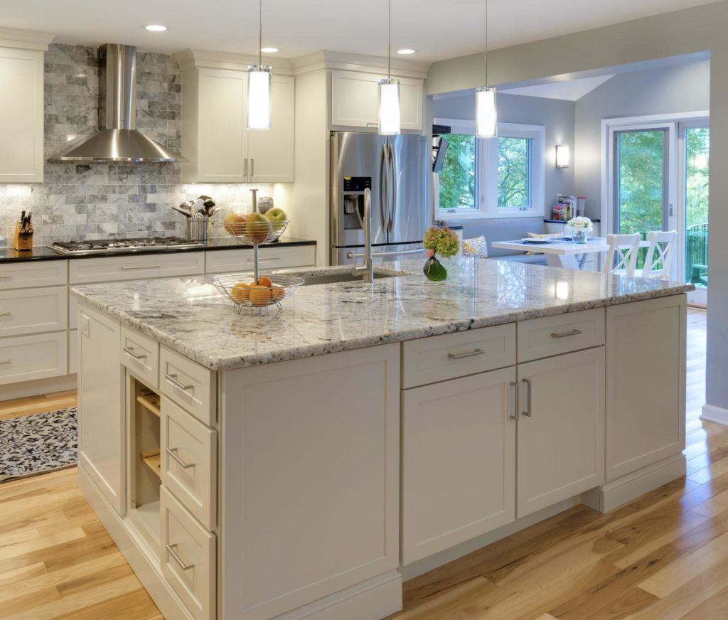 white kitchen with large island designed in framed vs frameless cabinetry