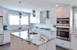 white L shape kitchen with island 