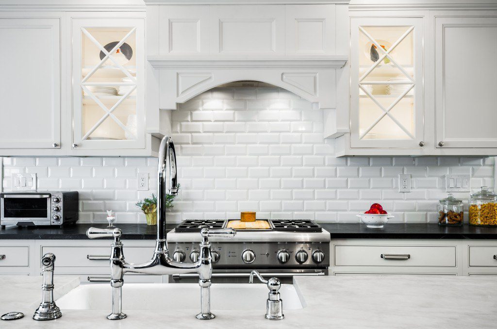 Open glass cupboards with back lighting provides even more light to this perfect kitchen