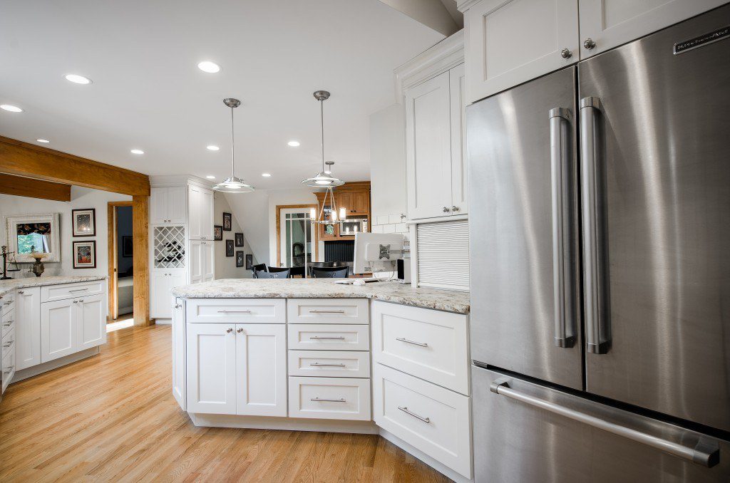 Stainless steel appliances match the cabinet handles and overall clean lines of the kitchen design