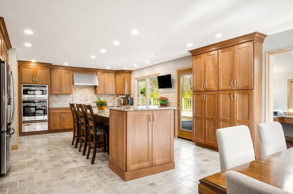 Kitchen featuring Bishop Utica birch door style cabinetry in a light finish.