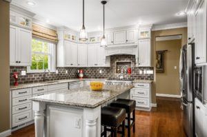 white kitchen with island and column posts. These are well made Bishop cabinets. When buying kitchen cabinets online or elsewhere always be careful