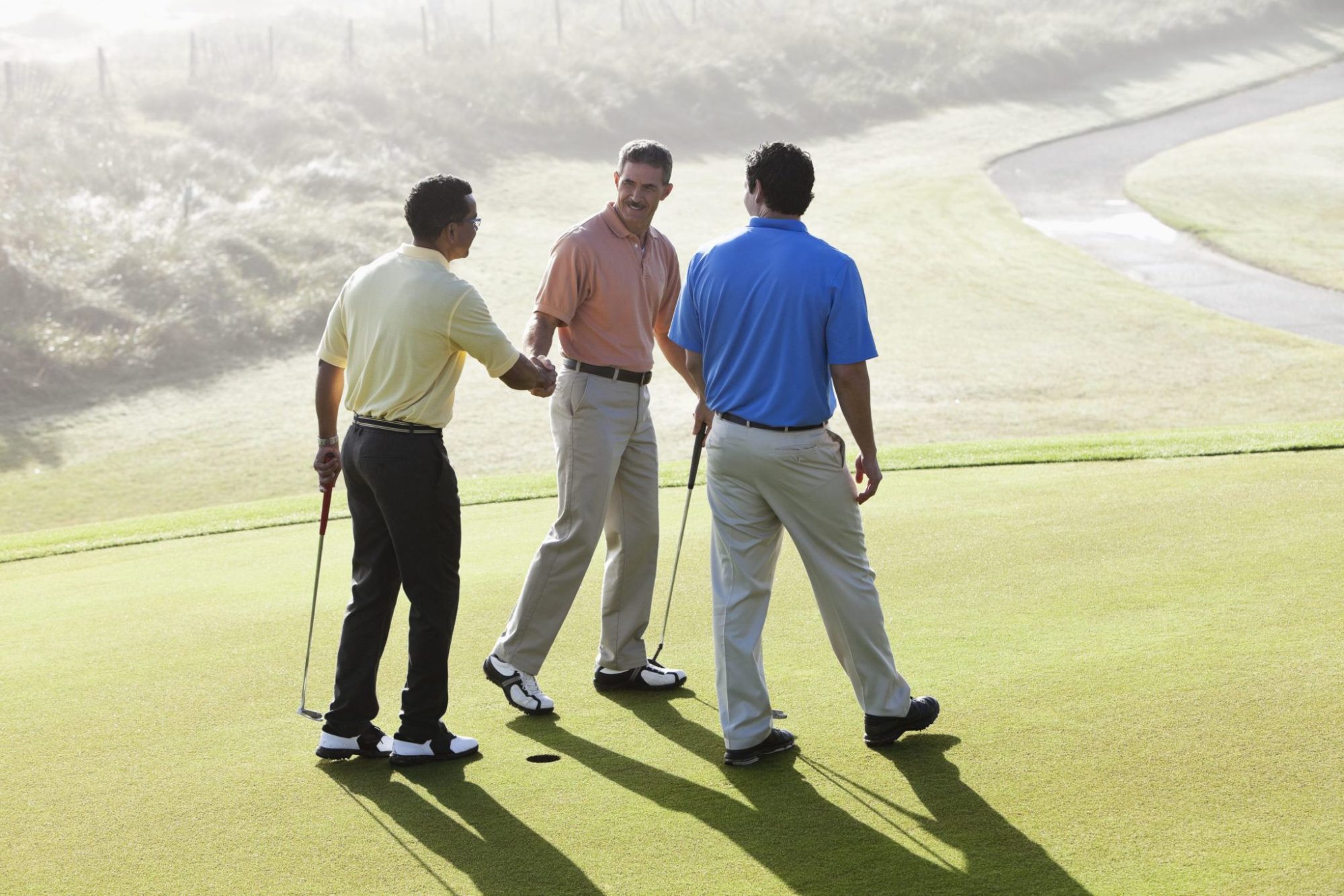 men golfing. Golfing with contractors is a way cabinet dealers get sales.