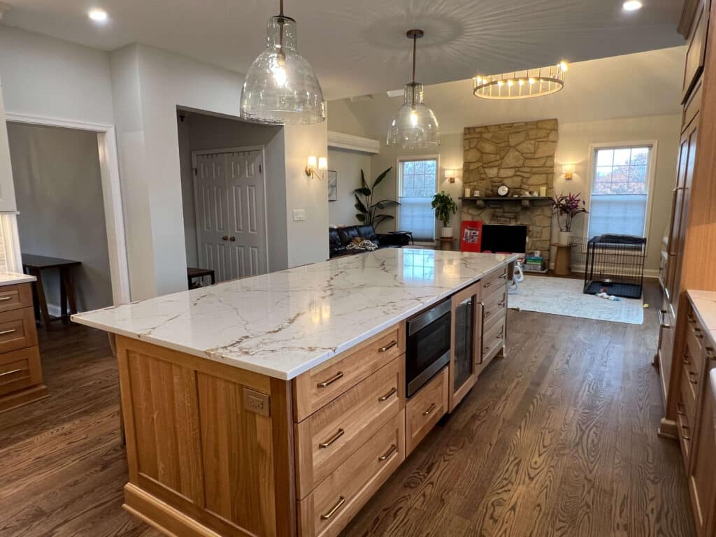 Tw-Tone kitchen with Island bar refrigerator and microwave drawer in the island