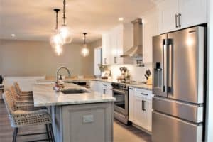 White and gray kitchen in Media, PA featuring Fabuwood Onyx Frost cabinets and a Horizon stained island with Quartzite countertop.