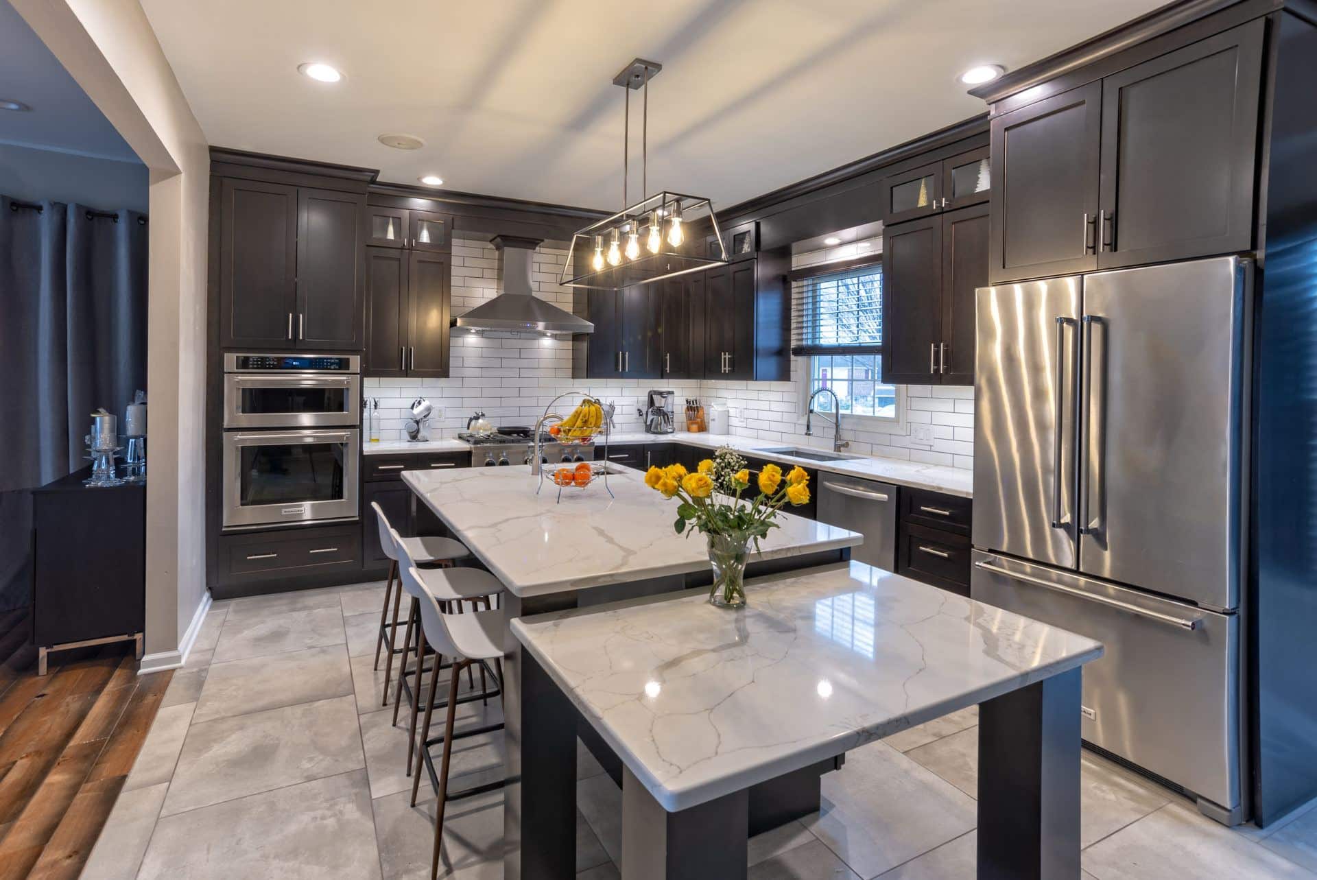Photo of dark shaker kitchen with two level Island
