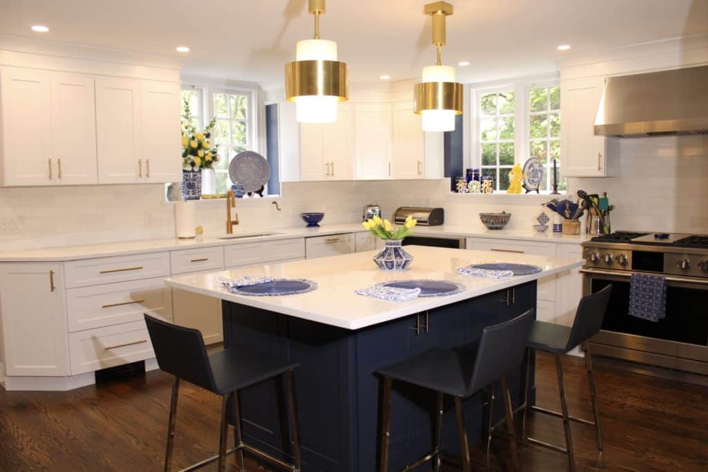 Blue and white kitchen in Wynnewood, PA featuring Fabuwood frost cabinets with an indigo island