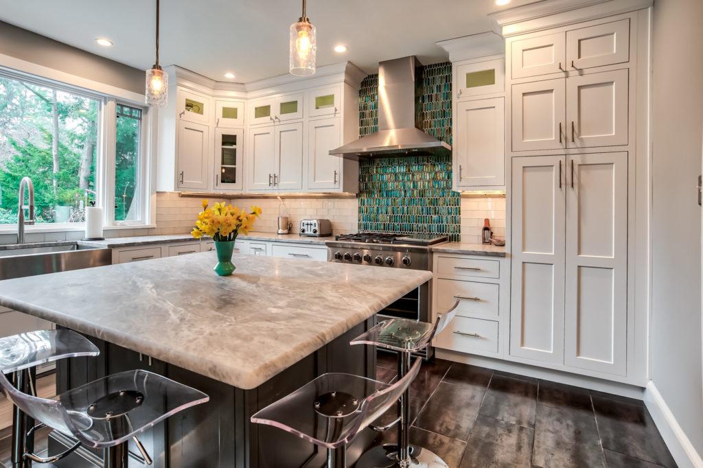 L shape kitchen with small island and green backsplash