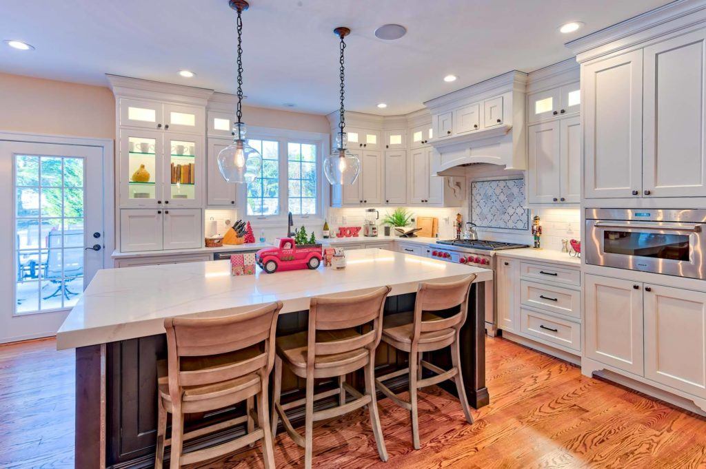 large white kitchen with blue island