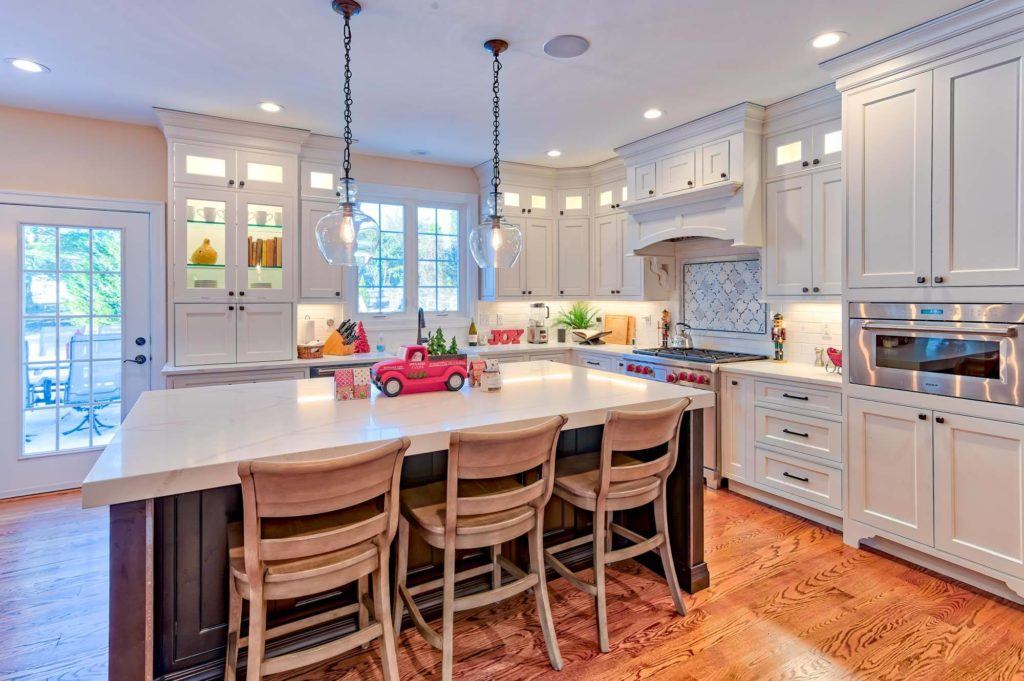 large white kitchen with blue island 