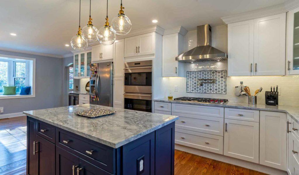 white kitchen with blue island 