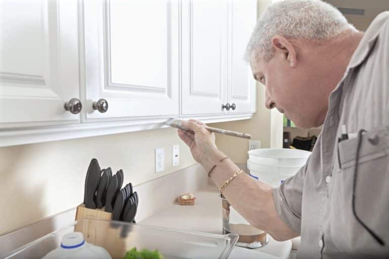 Handymman painting cabinets