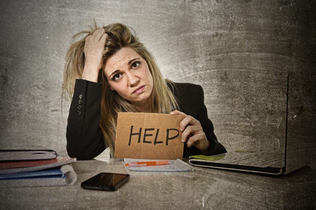 woman holding help sign 